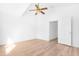 Bright bedroom features wood floors, white walls, ceiling fan and an open door to another room at 7510 N 59Th Ln, Glendale, AZ 85301