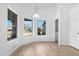 Sunny dining room with light fixture, light wood flooring and view of the street at 7510 N 59Th Ln, Glendale, AZ 85301