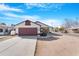 Charming single-story home features a red garage door and a well-maintained front yard, complemented by a clear blue sky at 7510 N 59Th Ln, Glendale, AZ 85301