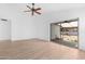 Bright living room with ceiling fan, sliding glass door to backyard for seamless indoor-outdoor living at 7510 N 59Th Ln, Glendale, AZ 85301