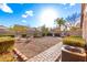 A spacious backyard features a gravel area, manicured bushes and a lush palm tree at 757 E Lovegrass Dr, San Tan Valley, AZ 85143