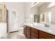 Bathroom featuring double sink vanity with white countertops and wood cabinets at 757 E Lovegrass Dr, San Tan Valley, AZ 85143