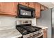 Close-up of the kitchen appliances, including a microwave and range with granite countertops at 757 E Lovegrass Dr, San Tan Valley, AZ 85143