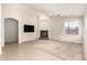 Comfortable living room featuring a cozy fireplace, mounted television, and tile to carpet flooring at 757 E Lovegrass Dr, San Tan Valley, AZ 85143