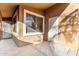 A covered patio features a neutral color scheme with a metal security door at 757 E Lovegrass Dr, San Tan Valley, AZ 85143