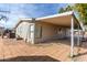 Cozy manufactured home featuring a covered parking area and low-maintenance landscaping at 7645 E Gale Ave, Mesa, AZ 85209