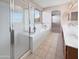 Bathroom with glass enclosed shower, soaking tub, and dual vanity at 801 S 120Th Ave, Avondale, AZ 85323