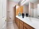 Bathroom vanity with dual sinks, wood cabinets, and decorative vase at 801 S 120Th Ave, Avondale, AZ 85323