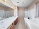 Bright bathroom featuring dual sink vanity, shower, and soaking tub at 801 S 120Th Ave, Avondale, AZ 85323