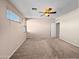 Empty bedroom with carpet, light colored walls, ceiling fan and a window at 801 S 120Th Ave, Avondale, AZ 85323