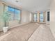 Open living room featuring neutral tones, large windows, and stylish tile and carpet flooring at 801 S 120Th Ave, Avondale, AZ 85323