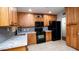 Bright kitchen with stainless steel appliances, granite countertops, and classic cabinetry at 824 W Luke Ave, Phoenix, AZ 85013