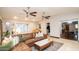 Cozy living room with plush sectional seating, modern ceiling fans, and natural light at 824 W Luke Ave, Phoenix, AZ 85013