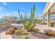 Backyard featuring desert landscaping, a large pool, and outdoor kitchen at 8320 E Arroyo Hondo Rd, Scottsdale, AZ 85266