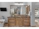 Bathroom features a wooden vanity with granite countertop, soaking tub, and tile flooring at 8320 E Arroyo Hondo Rd, Scottsdale, AZ 85266