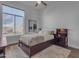 Bedroom with a platform bed, wood floors, a ceiling fan, and a large window at 8320 E Arroyo Hondo Rd, Scottsdale, AZ 85266