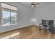 Bright bonus room with hardwood floors, a ceiling fan, and views of the outdoor pool at 8320 E Arroyo Hondo Rd, Scottsdale, AZ 85266