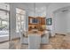 Bright dining area featuring a round wood table and comfortable seating near a large window at 8320 E Arroyo Hondo Rd, Scottsdale, AZ 85266