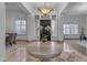 Elegant foyer with a stylish light fixture, marble floors, and views of the formal dining room at 8320 E Arroyo Hondo Rd, Scottsdale, AZ 85266