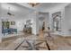 Wide shot of marble foyer featuring a decorative tiled starburst design, table with orchid, and other living spaces at 8320 E Arroyo Hondo Rd, Scottsdale, AZ 85266