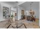 Elegant foyer with decorative mosaic tile flooring, chandelier, and views into dining room and other living spaces at 8320 E Arroyo Hondo Rd, Scottsdale, AZ 85266