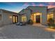 Charming home featuring a cozy front patio with wicker chairs, and manicured desert landscaping at 8320 E Arroyo Hondo Rd, Scottsdale, AZ 85266