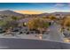 Attractive single-story home featuring desert landscaping, a paver driveway, and mountain views at 8320 E Arroyo Hondo Rd, Scottsdale, AZ 85266