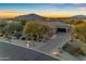 Beautiful single-story home with desert landscaping and mountain views at sunset at 8320 E Arroyo Hondo Rd, Scottsdale, AZ 85266