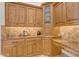 Close-up of kitchen cabinetry with granite countertops and decorative backsplash at 8320 E Arroyo Hondo Rd, Scottsdale, AZ 85266