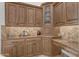 Close-up of kitchen cabinets featuring granite countertops and tile backsplash at 8320 E Arroyo Hondo Rd, Scottsdale, AZ 85266
