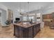 Bright kitchen featuring a large island, stylish pendant lighting, and seamless indoor-outdoor living at 8320 E Arroyo Hondo Rd, Scottsdale, AZ 85266