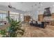 Open-concept kitchen featuring a large island, stainless steel appliances, and views of the living room at 8320 E Arroyo Hondo Rd, Scottsdale, AZ 85266