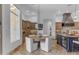 Well-lit kitchen with a breakfast nook, stainless appliances, and custom cabinets at 8320 E Arroyo Hondo Rd, Scottsdale, AZ 85266