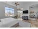 Bright main bedroom with a ceiling fan, marble floors, a large window and sliding doors to the outdoor space at 8320 E Arroyo Hondo Rd, Scottsdale, AZ 85266