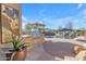 Outdoor kitchen featuring stainless steel grill and bar seating with a view of the pool at 8320 E Arroyo Hondo Rd, Scottsdale, AZ 85266