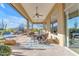 Extended covered patio with dining area overlooking landscaped backyard and pool at 8320 E Arroyo Hondo Rd, Scottsdale, AZ 85266