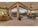 Covered patio with furniture, ceiling fans, and views of the backyard pool at 8320 E Arroyo Hondo Rd, Scottsdale, AZ 85266