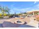 Outdoor pool area with a fire pit, landscaping, lounge chairs and umbrellas at 8320 E Arroyo Hondo Rd, Scottsdale, AZ 85266