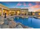 A backyard pool includes water features, spa, fire pit, and desert landscaping at 8320 E Arroyo Hondo Rd, Scottsdale, AZ 85266