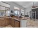 Wet bar with stone countertops, ample cabinet space, and views of the outdoor pool and landscaping at 8320 E Arroyo Hondo Rd, Scottsdale, AZ 85266