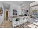 A wet bar featuring a countertop bar with seating, and views of the outdoor living area at 8320 E Arroyo Hondo Rd, Scottsdale, AZ 85266