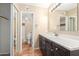 Bathroom with tan walls, terracotta tile floors, and dark cabinets with marble countertop at 8558 E Indian School Rd # H, Scottsdale, AZ 85251