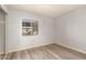 Bedroom with wood laminate floors, a window, and light grey walls at 8558 E Indian School Rd # H, Scottsdale, AZ 85251