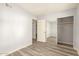 Bedroom with wood laminate floors, a sliding closet, and light grey walls at 8558 E Indian School Rd # H, Scottsdale, AZ 85251