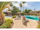 Community pool with ample lounge seating, sun umbrellas and desert landscaping at 8558 E Indian School Rd # H, Scottsdale, AZ 85251