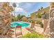 Community pool with lounge chairs surrounded by desert landscaping and palm trees at 8558 E Indian School Rd # H, Scottsdale, AZ 85251