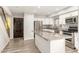 Kitchen area showcases a kitchen island, stainless steel appliances, and white cabinets, perfect for cooking at 8558 E Indian School Rd # H, Scottsdale, AZ 85251