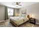 Bedroom with a cozy rug, fan, a unique textured bedspread, and contemporary decor at 8640 E Dianna Dr, Scottsdale, AZ 85254