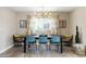 Elegant dining room featuring a modern chandelier, neutral walls, and a view of the outdoor scenery at 8640 E Dianna Dr, Scottsdale, AZ 85254