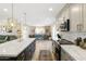 Bright and airy kitchen with an island, stainless steel appliances, gray cabinets, and a view into the dining area at 8640 E Dianna Dr, Scottsdale, AZ 85254